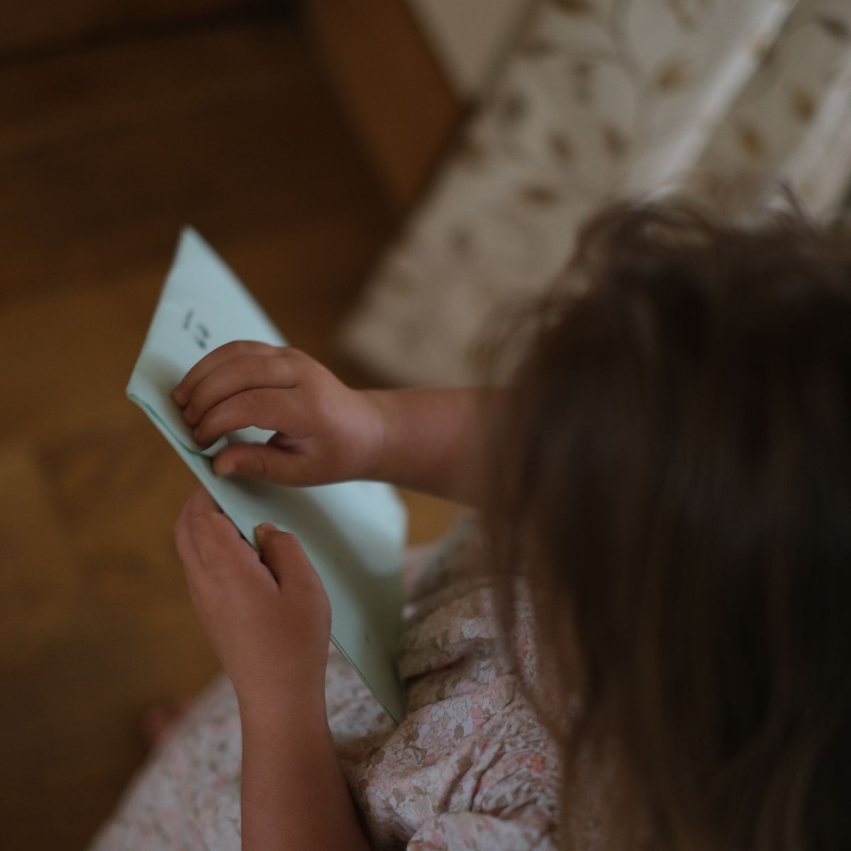 Child opening personalised post through the letterbox
